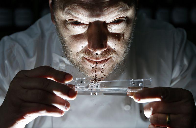 Belgian chocolatier Persoone snorts cocoa powder off his Chocolate Shooter in his factory in Bruges